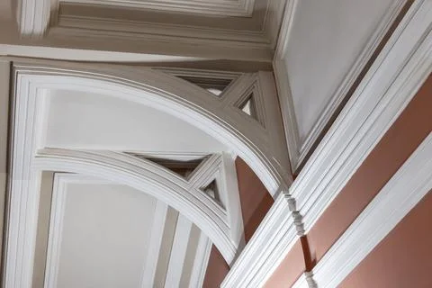 White cantilevers holding a ceiling structure. Classic interior Stock Photos