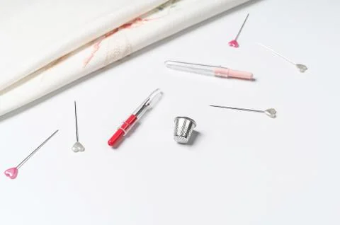 White canvas background with sewing tools and colorful threads. Mockup for hobby Stock Photos