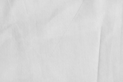 White canvas with delicate striped pattern, crumpled. Fabric texture, backgro Stock Photos