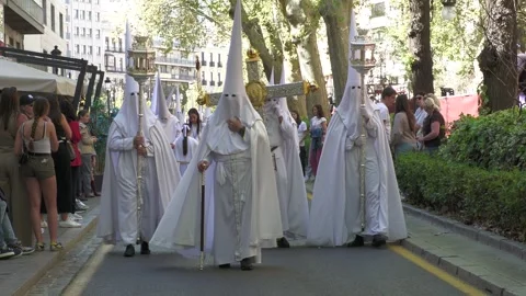 White Capirotes Carrying Cross During Semana Santa in Granada Stock Footage 336025260