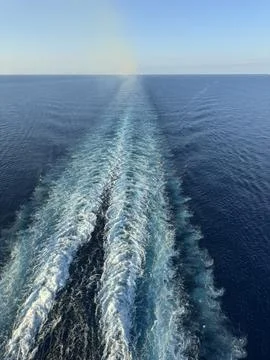 White capped ocean wave wake behind ship vertical photo Stock Photos