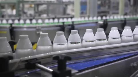 White-Capped Sake Bottles Advancing on the Bottling Line Stock Footage 340010805