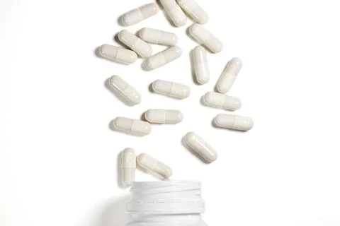 White capsule bottle on a white background. Epidemic, painkillers, healthcare Stock Photos