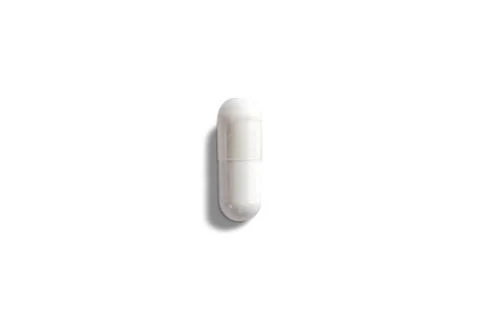 White capsule, isolated on wtite background. Healthcare medicine concept Stock Photos