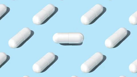 White capsule pills on blue background , Medicine concept. Stock Footage 278279241