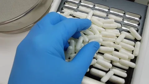 White capsules in a capsule machine Stock Footage 145361613