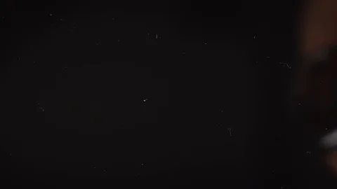 The white capsules fall out of the glass jar.Black background,slow motion,macro Stock Footage 127620099