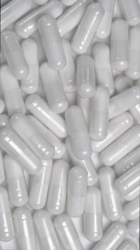 White capsules or tablets rotating background Stock Footage 316918578