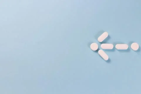 White capsules in the shape of a small arrow indicate empty space on a blue b Stock Photos