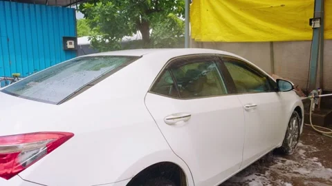 White car is cleaned using strong pressure hose Video stock 297238963