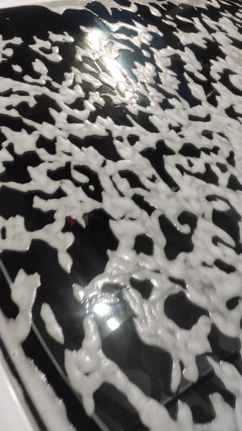 White car covered in active soap foam at a self-service car wash Stock Footage 333593770