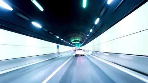 White car drives fast through bright modern highway tunnel Video stock 333816442
