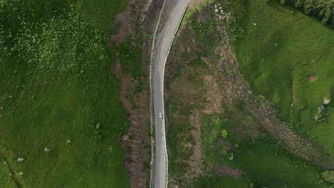 White car drives on a mountain road Stock Footage 136433374