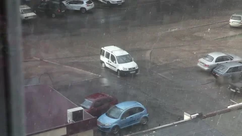 White car drives in the rain Stock Footage 146912876