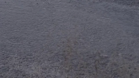 A white car drives through a puddle in slow motion Stock Footage 75443417