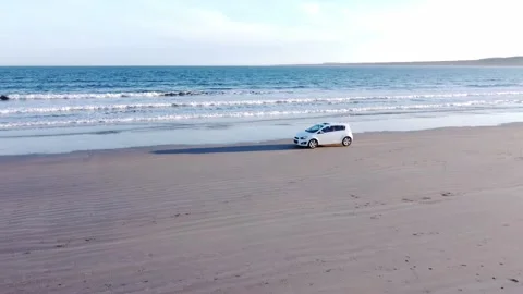White car driving on beach Stock Footage 155313670