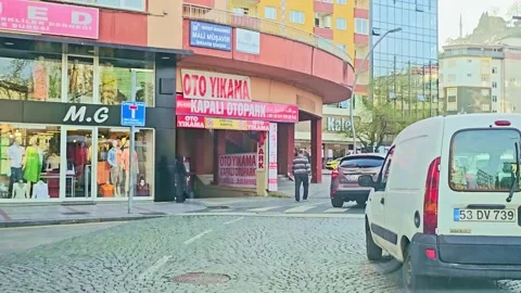 A white car driving down a cobbles Stock-Footage 272807227