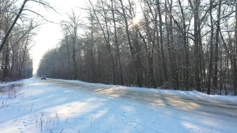 White car fast riding through snow covered icy road. SUV drive at winter Stock Footage 257670806