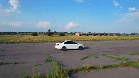 White car is going on road. Drone is following to a car. Stock Footage 158673836