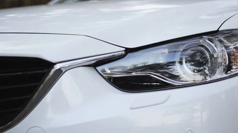 White car headlights closeup with camera moving up Stock Footage 88882128