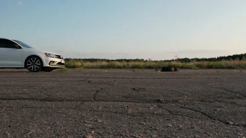 White car is leaving. Poltavska oblast, Ukraine 25.07.2021 Stock Footage