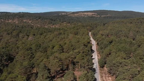 White car on a mountain road . Dron Stock Footage 124843864