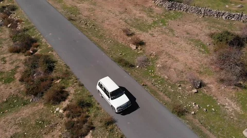 White car on a mountain road Stock Footage 124843827