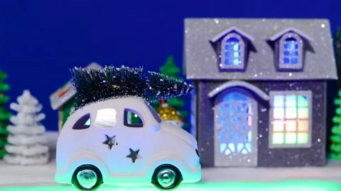 A white car moves against the backdrop of a Christmas town Stock Footage 306044150