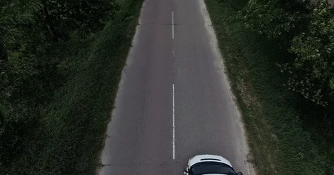 White car moving fast on two lane road in forest, above view Video stock 84947801