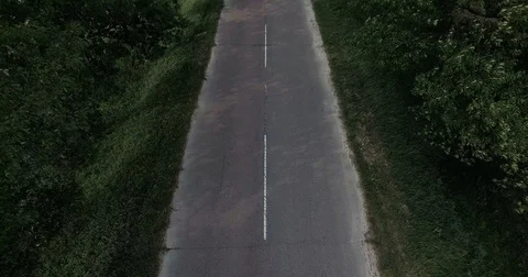 White car moving fast on two lane road in forest, above view Stock Footage 84966285