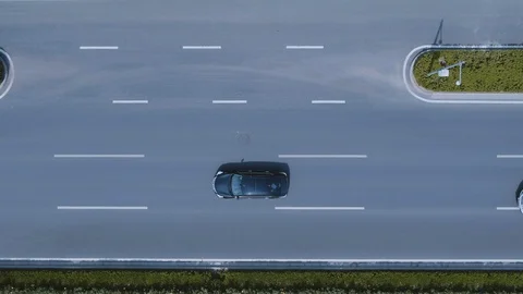 A white car is overtaking a black car on a straight path. 4K. Drone Stock Footage