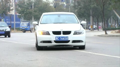 White car parked on the roadside Stock Footage 253773229