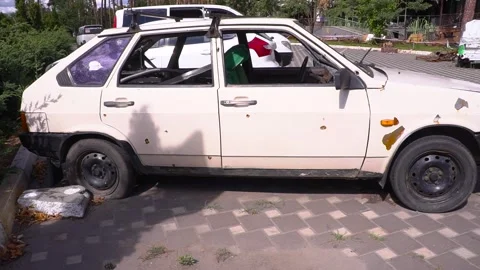 White car parked on roadside with wheels on land vehicle Stock Footage 274572107