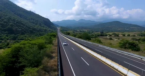 White car passing trough mountains Stock Footage 101655897