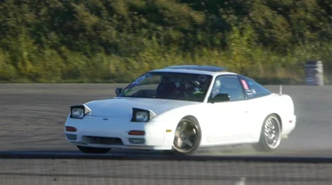 White car rounds corner on race track in slow motion. Stock Footage 59747351