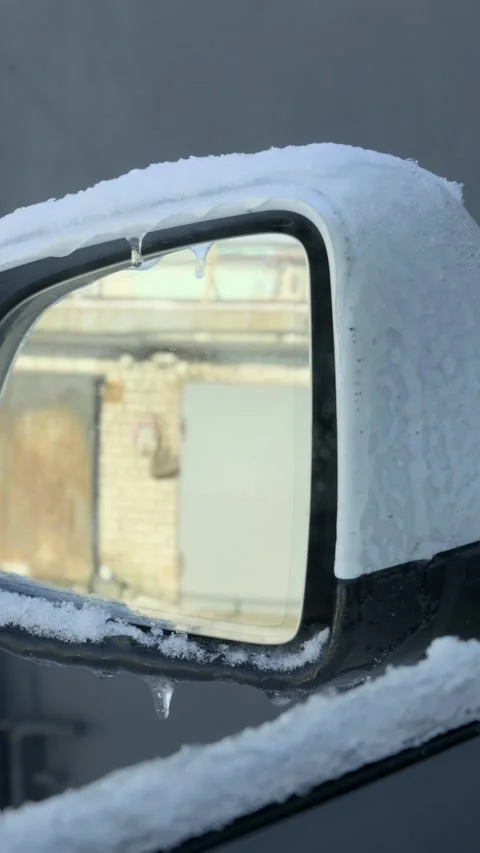 White car side mirror covered in snow and ice with icicles hanging 스톡 동영상 329982401