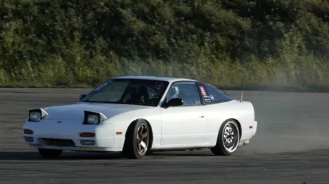 White car slides around corner at drift racing event. Stock-Footage 59746864