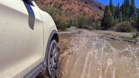 A white car is speeding through a large muddy puddle Video stock 317169191