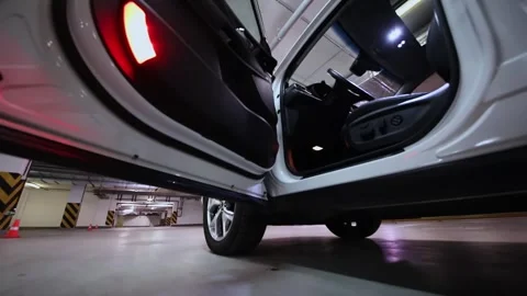 White car stand with opened door on underground parking Stock Footage 276370618