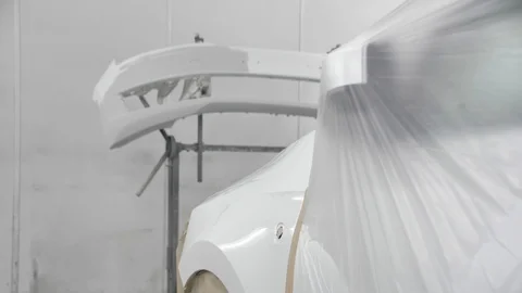 White car is standing in a spray booth covered with a transparent film. Ready to 库存影片 125884178