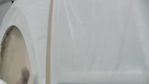 White car is standing in a spray booth covered with a transparent film. Ready to Stock Footage 125884239