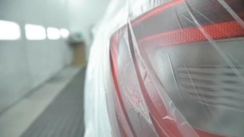 White car is standing in a spray booth covered with a transparent film. Ready to Stock Footage 125884280