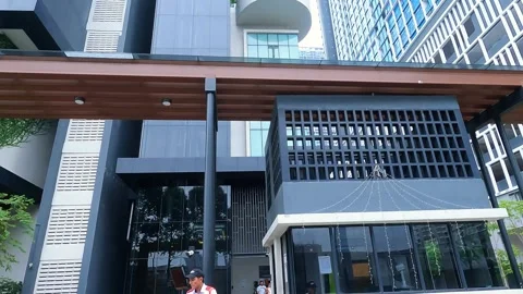 The white car stops at the gate before entering the area, and the security Stock Footage 338365309