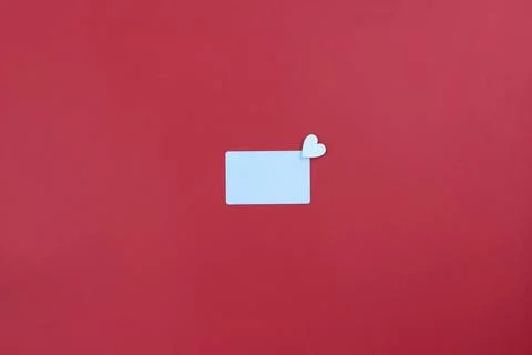 White card on red background. Copy space. Place for text. Minimalism. Stock Photos