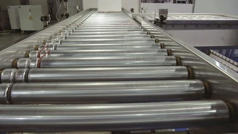 White cardboard boxes are moved along a roller conveyor. Stock Footage 99917430