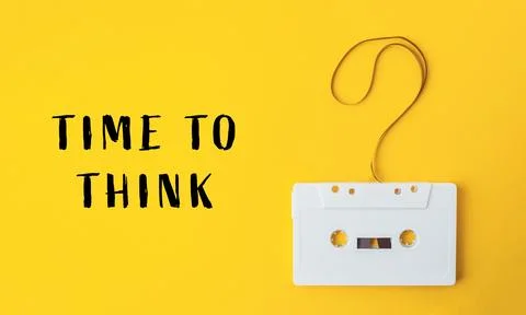 White cassette tape is hanging from a string with a question mark on it Stock Photos