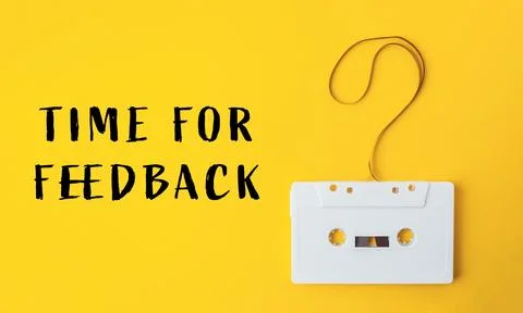 White cassette tape is hanging from a string with a question mark on it Stock Photos