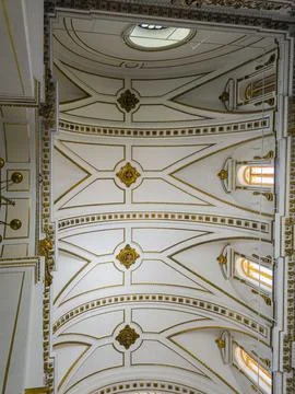 White cathedral ceiling with ribbed vaults and golden medallions in a histo.. Stock Photos