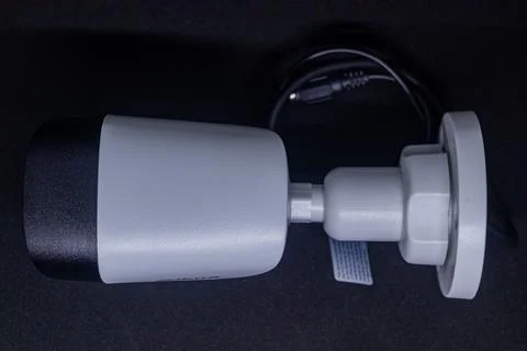 White CCTV Security Camera with Black Lens Housing on Black Studio Backgroun Stock Photos