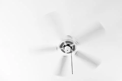 White ceiling electrical fan in motion Stock Photos